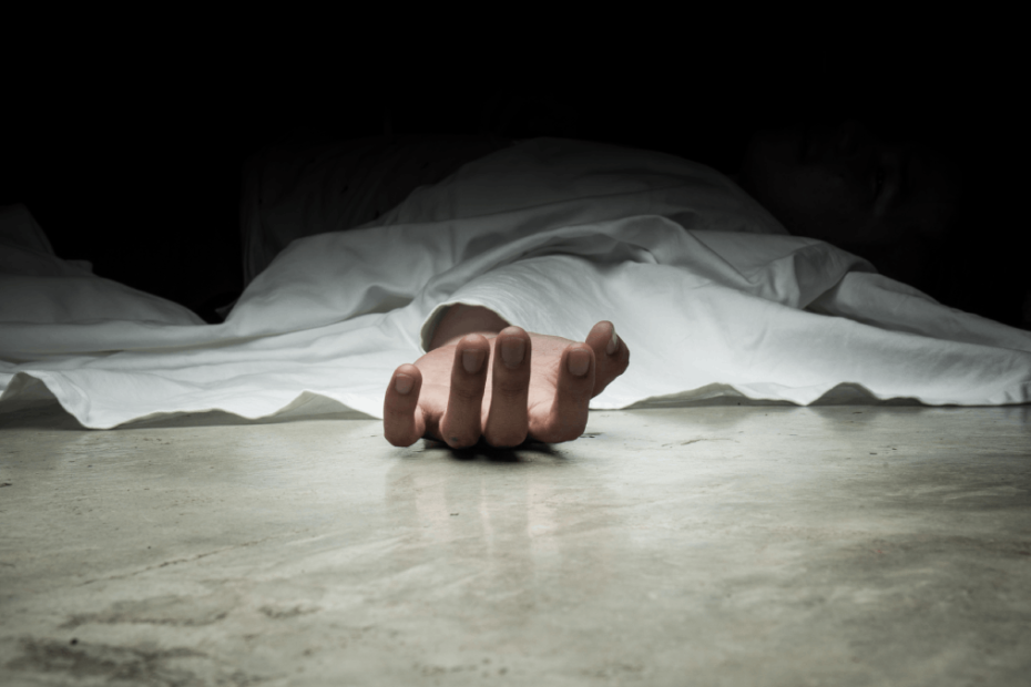 Hand of a lifeless person lying on the floor, symbolizing tragedy and loss.